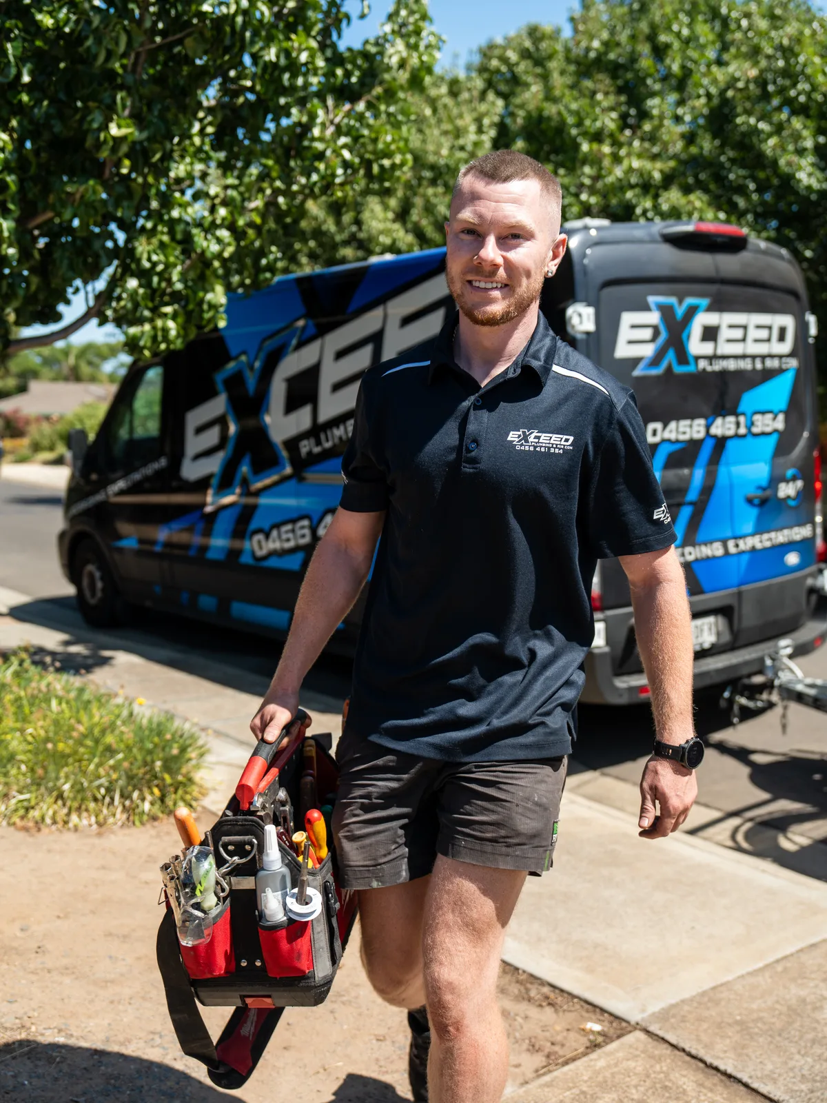 Technician walking up the driveway with tools